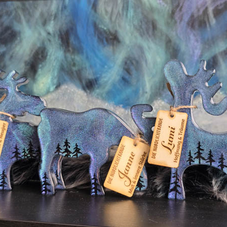 Set aus drei handgefertigten Resin-Deko-Elchen – Janne, Mikka und Lumi – mit schimmernden Polarlichtern, perfekte Winter- und Weihnachtsdeko.